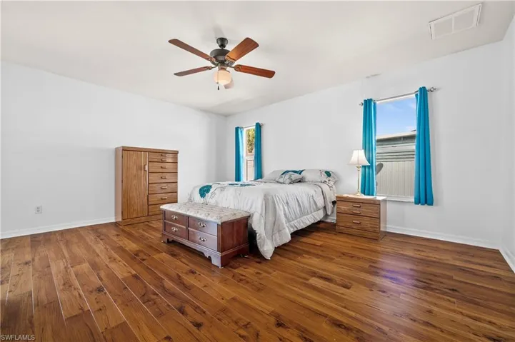 Bedroom featuring dark wood-style flooring and a ceiling fan