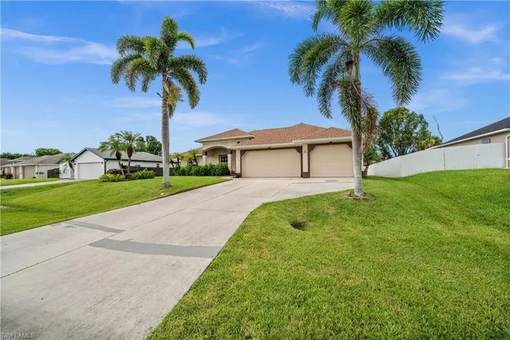 Mediterranean / spanish-style house featuring an attached garage, concrete driveway, and stucco siding