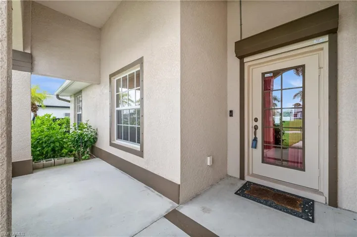 View of exterior entry featuring stucco siding