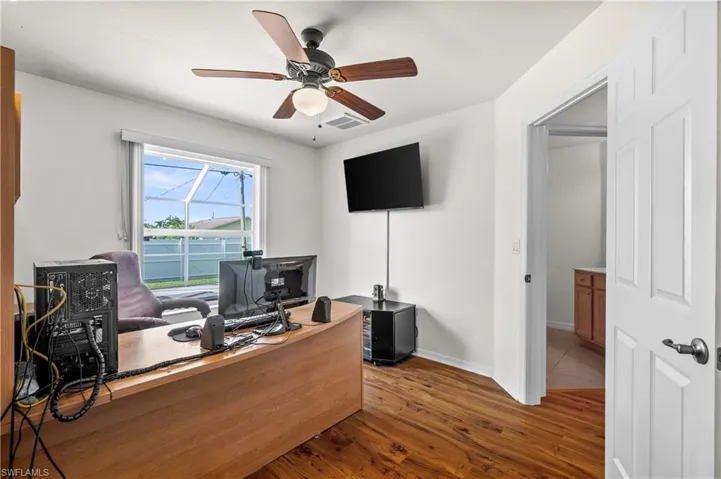 Office area with dark wood-type flooring and ceiling fan (4th bedroom)