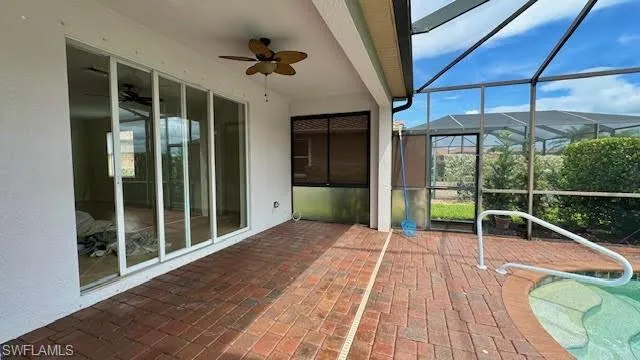 Unfurnished sunroom featuring ceiling fan