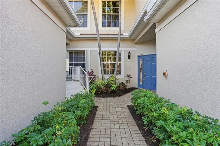 View of exterior entry with stucco siding