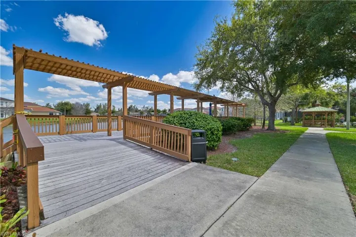 Deck featuring a lawn, a water view, and a gazebo