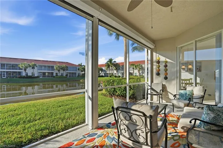 Sunroom with a water view and a textured ceiling