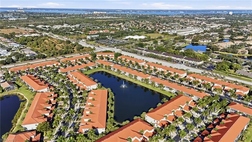 Aerial perspective of suburban area featuring a large body of water