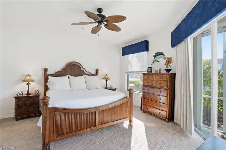 Bedroom featuring access to exterior, light carpet, and ceiling fan