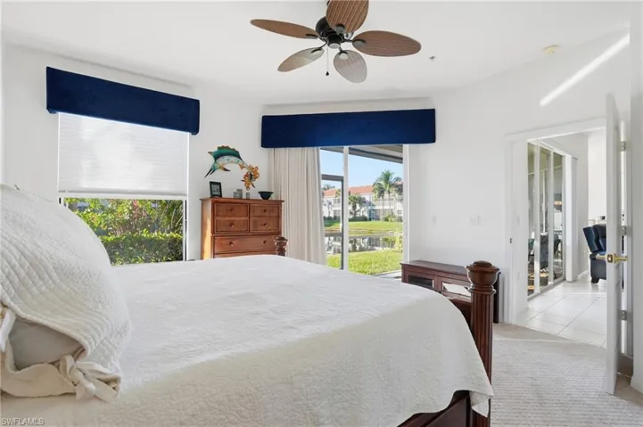 Tiled bedroom with access to exterior and ceiling fan
