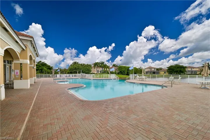 Community pool with a patio