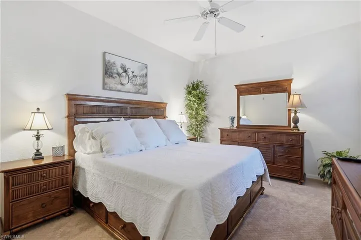 Bedroom with light carpet and ceiling fan