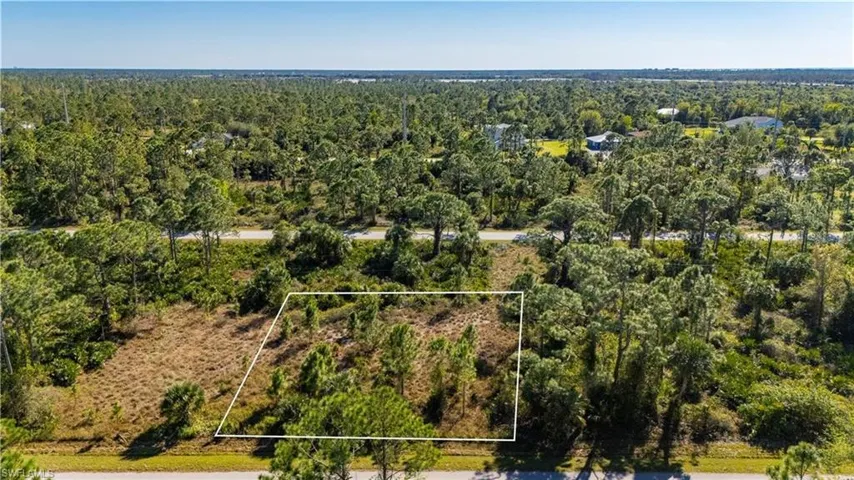 View of property location featuring a forest and property parcel outlined