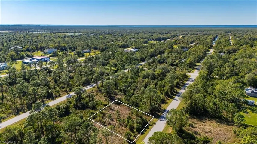 Aerial view of property's location featuring a heavily wooded area and property boundaries highlighted