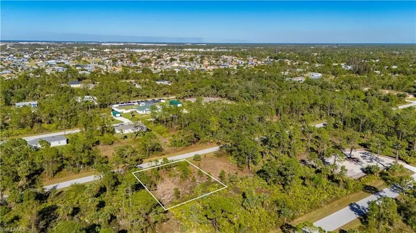 View of property location featuring property boundaries highlighted and a forest
