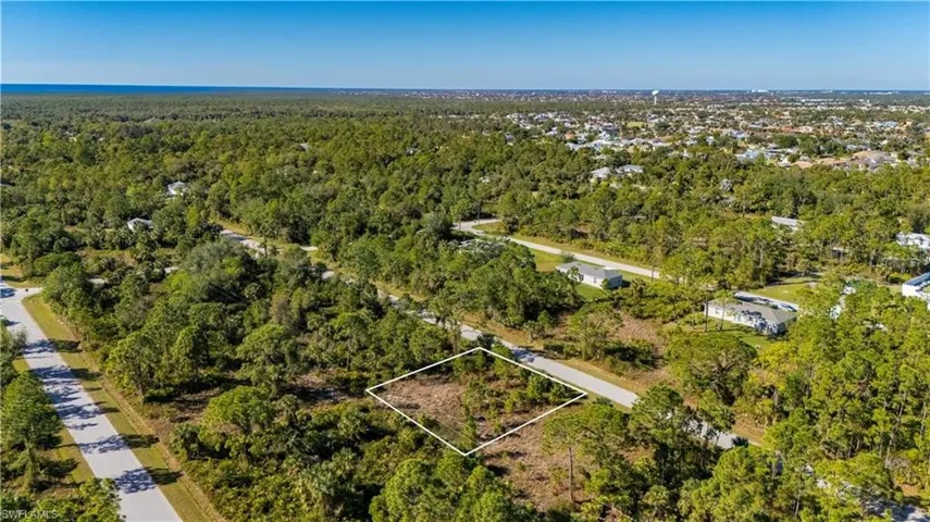 View of property location featuring a heavily wooded area and property parcel outlined