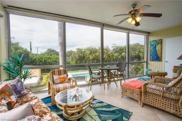 Sunroom featuring ceiling fan and plenty of natural light