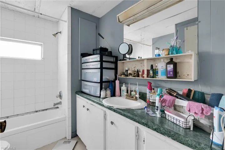 Bathroom with vanity and shower / tub combination