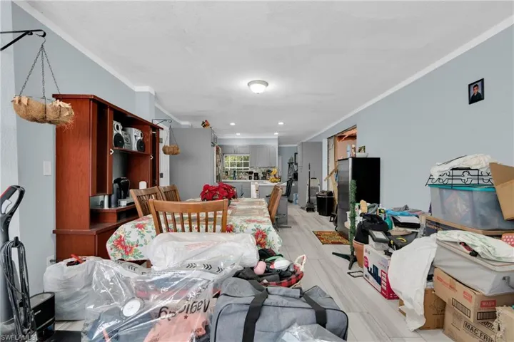 Living area with ornamental molding and recessed lighting