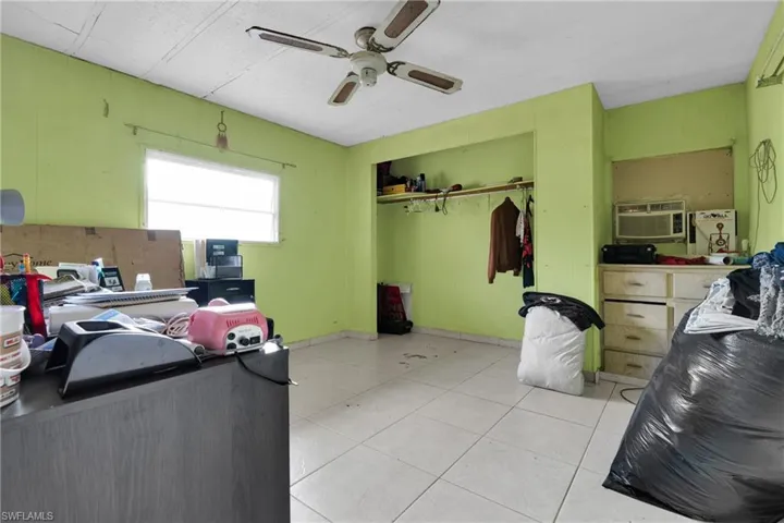 Office with ceiling fan and a wall unit AC
