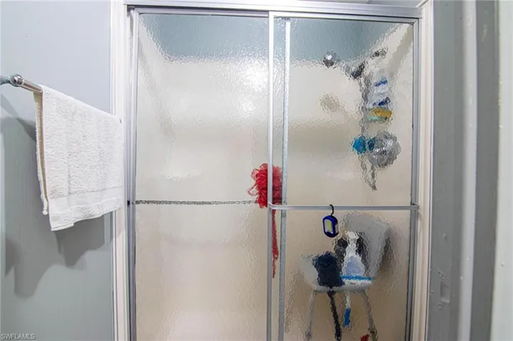 Full bathroom featuring a stall shower