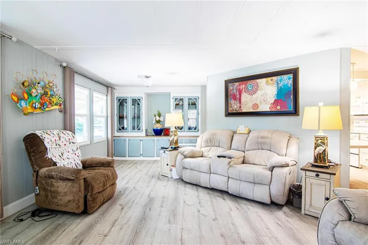 Living area with light wood-style flooring and baseboards