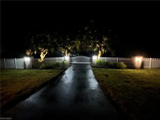 gated entrance at night
