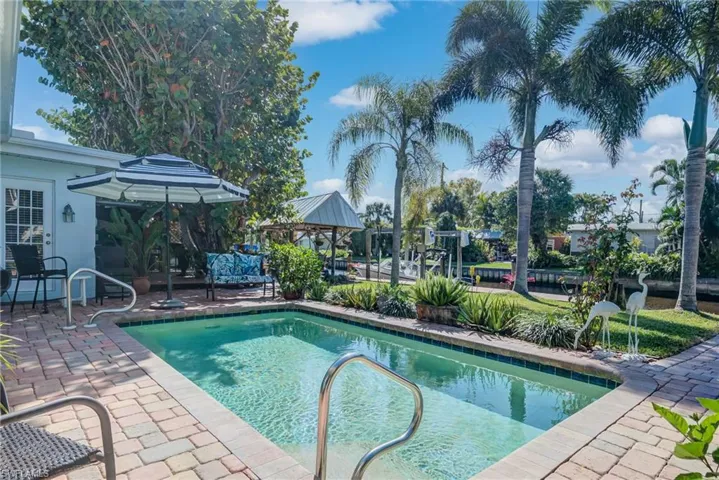 200 SQ. FT. OF BRICK PAVERS, BELOW GROUND POOL, ELEGANT PALM TREES, SOUTHERN EXPOSURE
