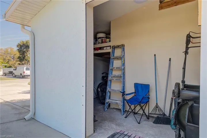 RIGHT SIDE OF HOME WITH ADDITIONAL STORAGE FOR LAWN EQUIPMENT, ETC.  THERE IS A DOOR THAT IS RAISED RIGHT NOW.