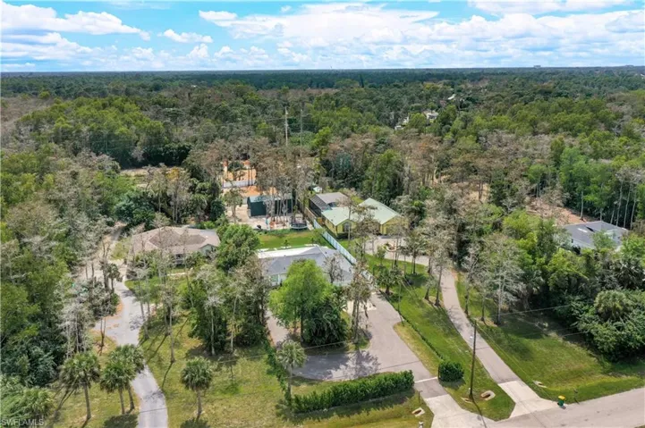 Aerial view of property's location with a forest