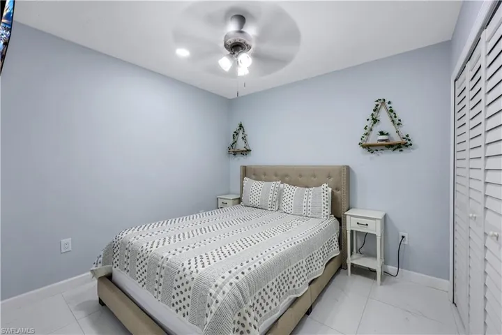 Bedroom with baseboards and a ceiling fan