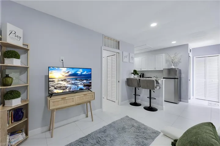 Living room featuring baseboards and recessed lighting