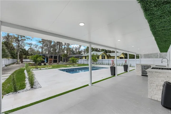View of swimming pool with patio surround and a fenced backyard