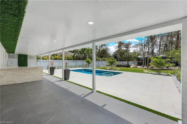 View of pool featuring patio surround and a fenced backyard