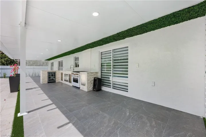 View of patio featuring an outdoor kitchen and wine cooler