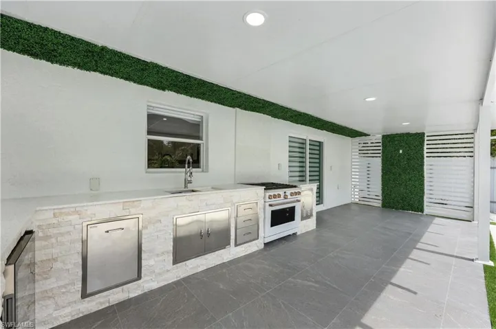 View of patio / terrace featuring exterior kitchen and wine cooler