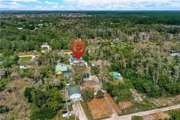 Aerial view of property's location featuring a forest