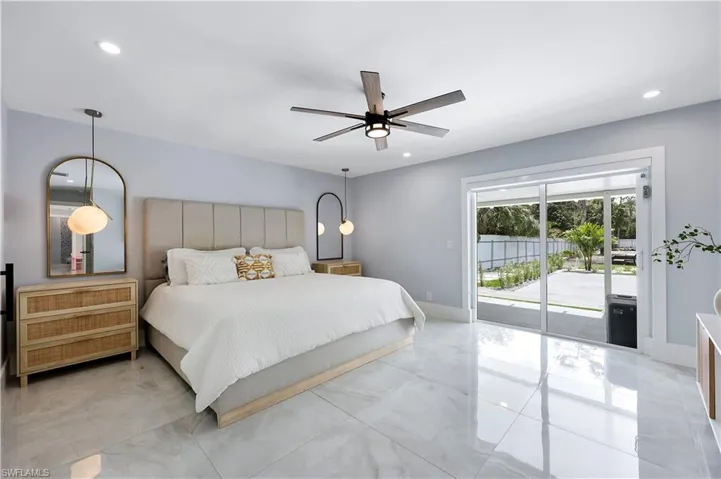 Bedroom featuring access to exterior, a ceiling fan, recessed lighting, and light marble finish flooring