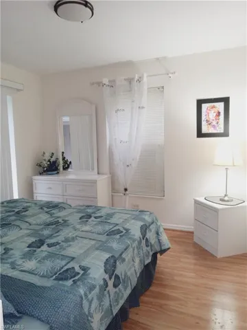 Bedroom with light wood-style flooring and baseboards