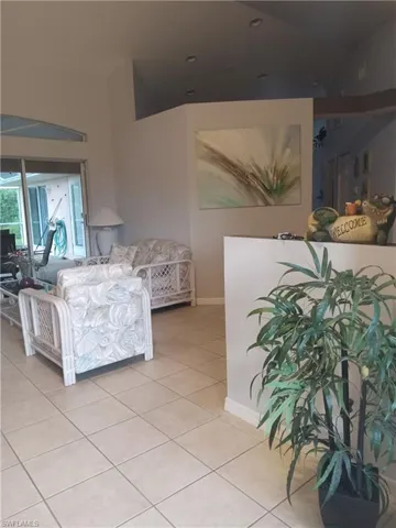Living room featuring light tile patterned floors and baseboards