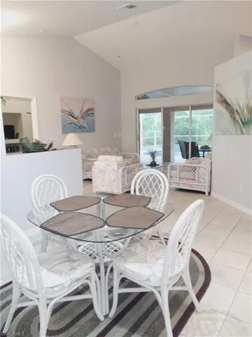 Dining room with vaulted ceiling and light tile patterned floors