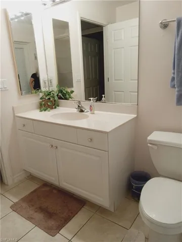 Bathroom featuring vanity, toilet, and tile patterned floors