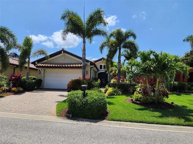 View of front of property with a front lawn and a garage
