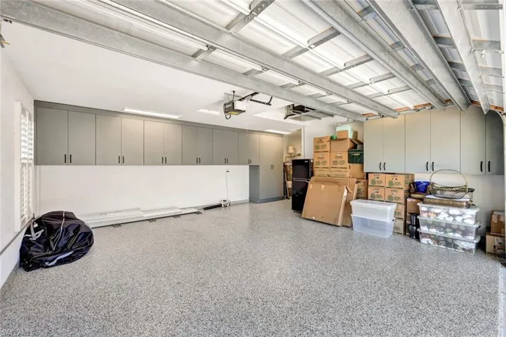 Oversized two-car garage, upgraded with custom cabinetry and epoxy flooring.
