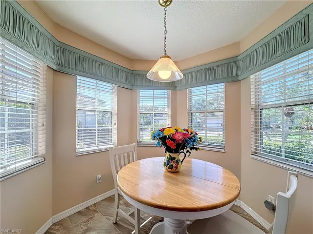 Tiled dining room with a textured ceiling