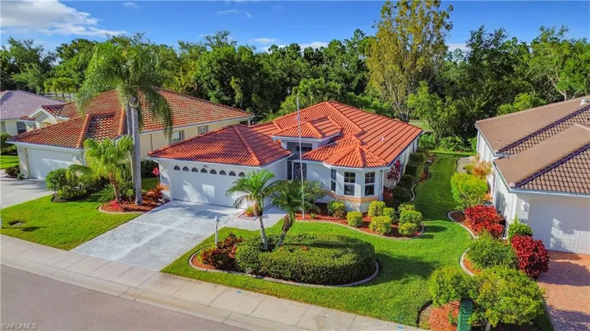 View of front of property with a garage and a front lawn