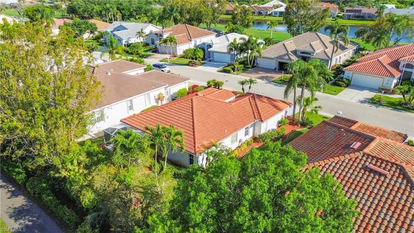 Birds eye view of property with a water view