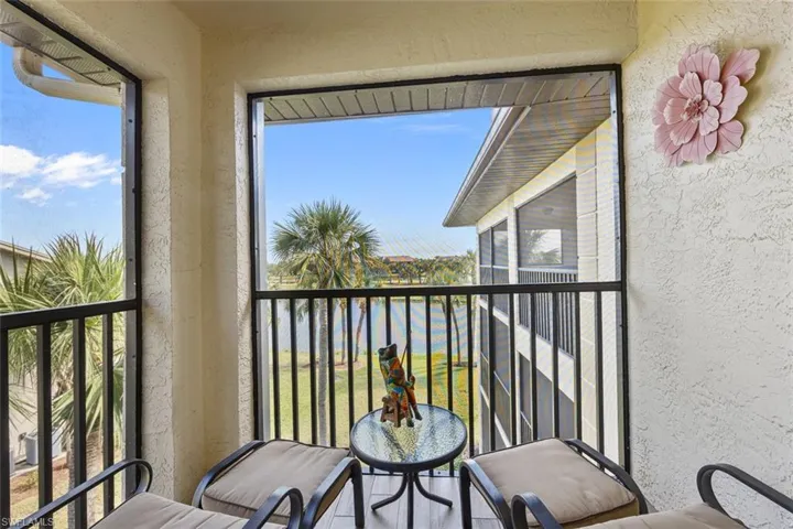 Back lanai that extends across the length of the unit & overlooks water & golf course.