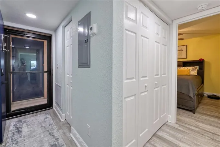 Corridor with light hardwood / wood-style flooring