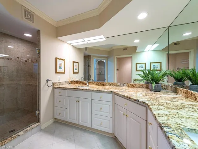 Loads of space in this bathroom boasting granite counters and walk in shower.