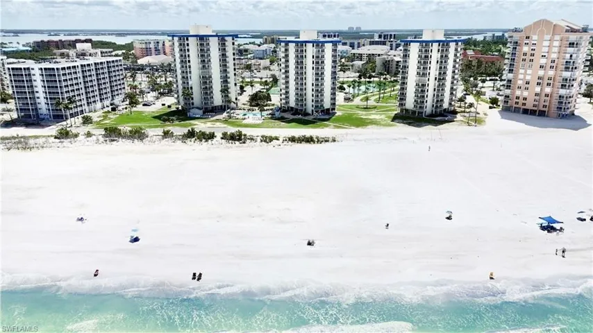 Looking in from the Gulf , complex is 3 high rise buildings with blue stripe on top.