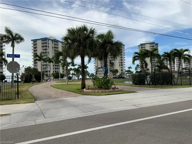 Entrance to complex , many tall palms, and beautiful landscaping !