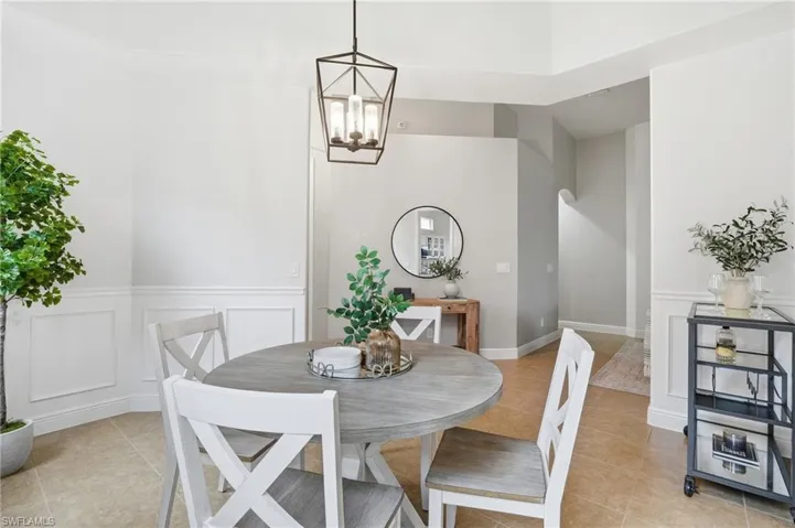 Dining area with tile flooring and wainscoting